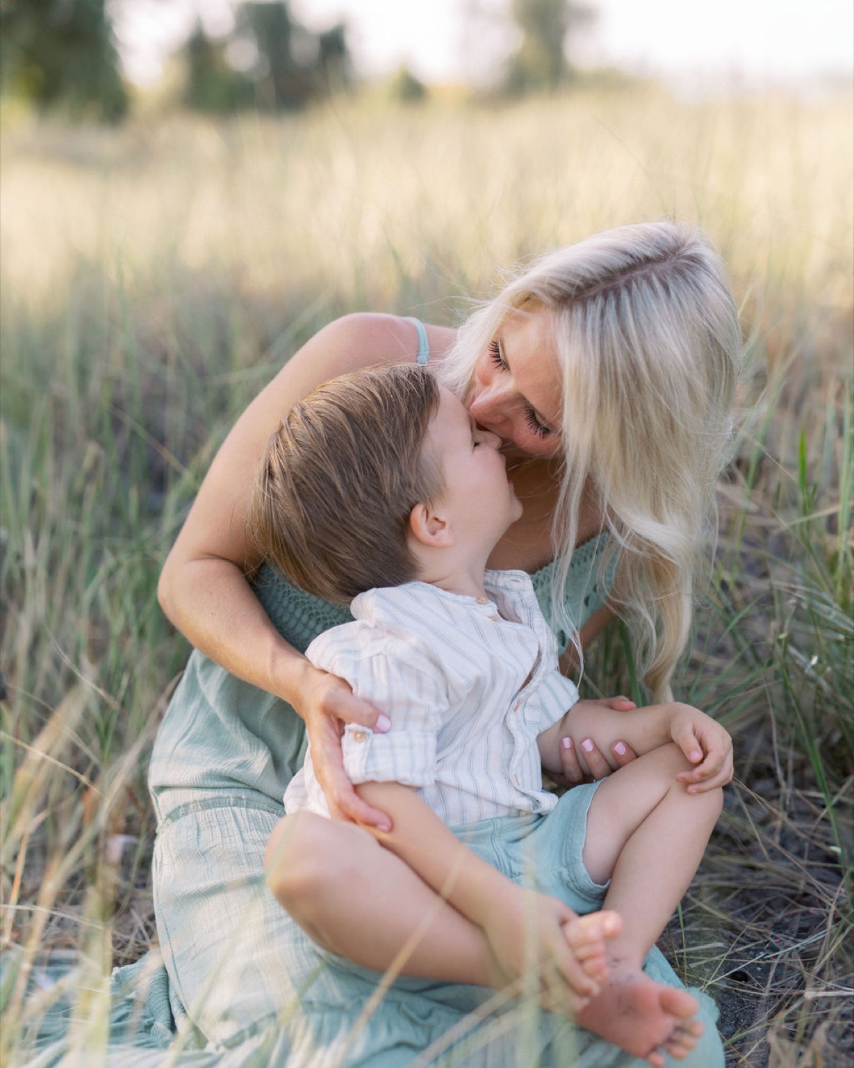 A luminous portrait of a mother and her son among the beach grass