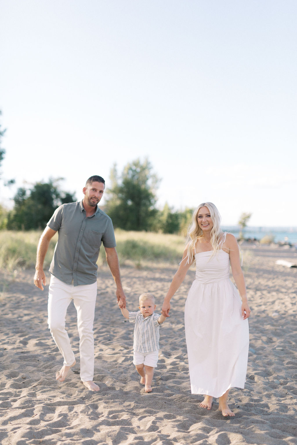 A family walking together on the sand at Hamilton Beach