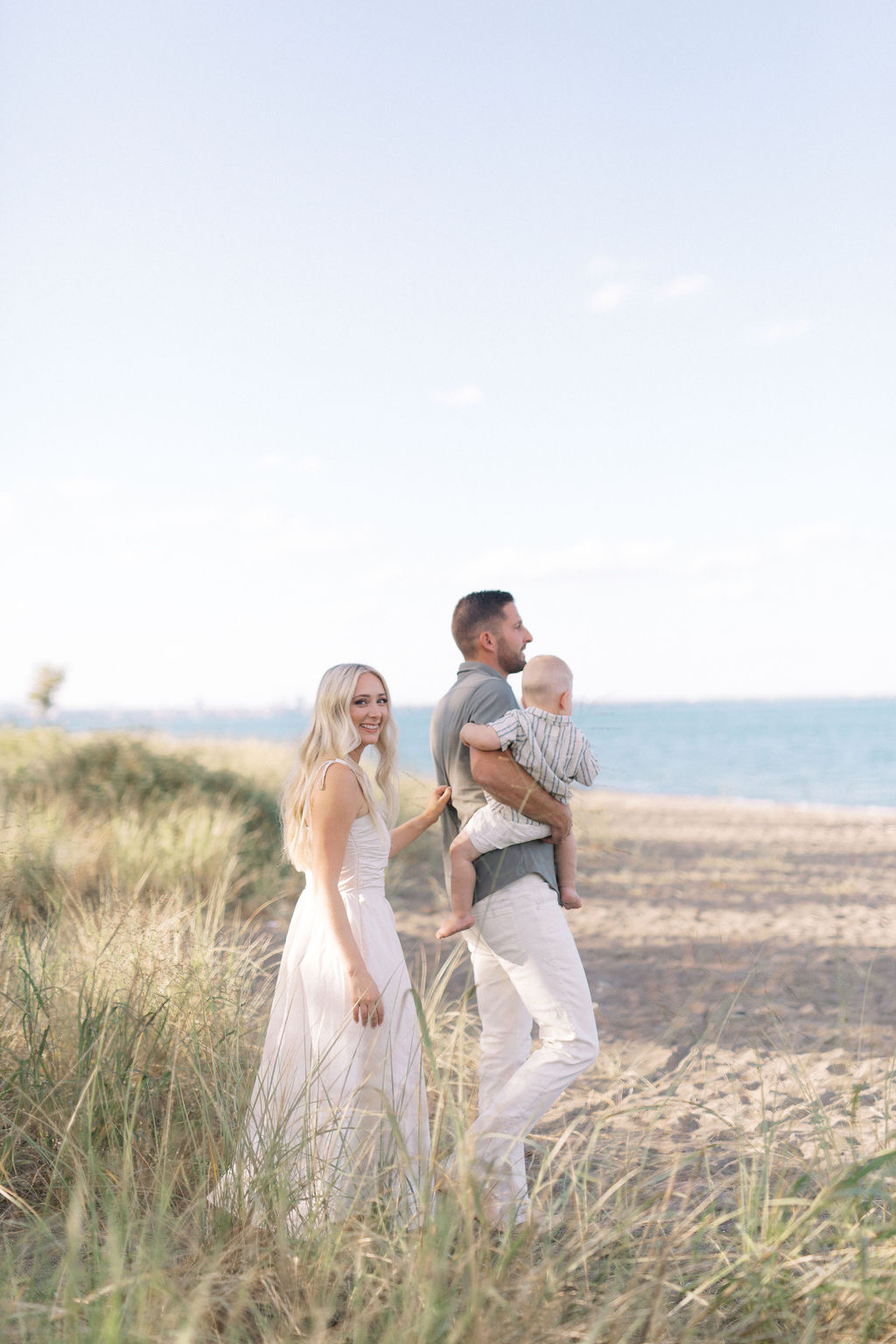 A family walking together through the grasses at Hamilton Beach